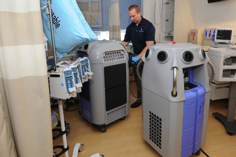 Mike Duclos sets up two disinfecting "robots," machines that vaporize hydrogen peroxide to fill sealed rooms and disinfect all sufaces at Johns Hopkins hospital in Baltimore, Maryland, on December 26, 2012. (Algerina Perna/Baltimore Sun/MCT)
