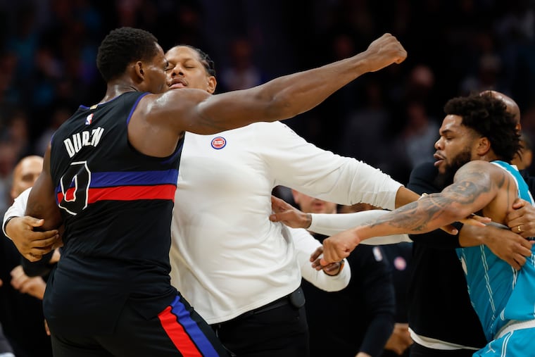 Pistons center Jalen Duren (left) throws punches with Hornets forward Miles Bridges during a fight on the court in the second half Monday.