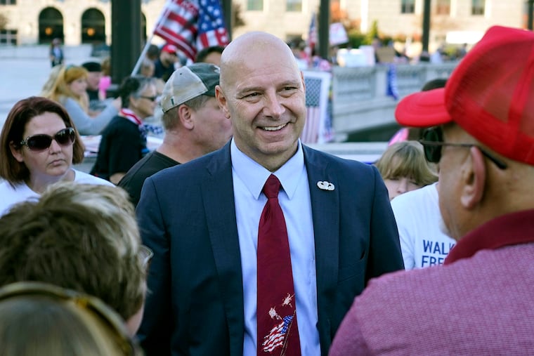Pennsylvania State Sen. Doug Mastriano (R., Franklin) (center) speaks to supporters of President Donald Trump as they demonstrate outside the state Capitol in Harrisburg after Democrat Joe Biden defeated Trump to become 46th president of the United States. Mastriano said in a statement July 7 that, as chair of the Senate Intergovernmental Operations Committee, he issued letters to several counties, requesting "information and materials needed to conduct a forensic investigation of the 2020 General Election and the 2021 Primary."