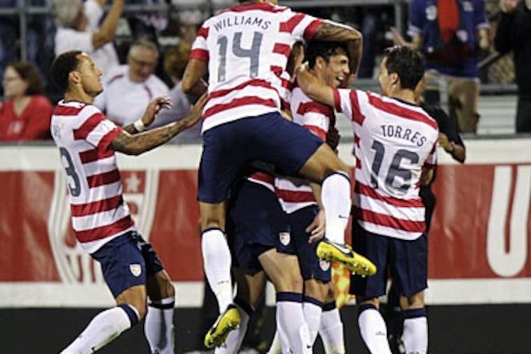 United States players celebrate a goal by Herculez Gomez against
Jamaica during the second half. (Jay LaPrete/AP)