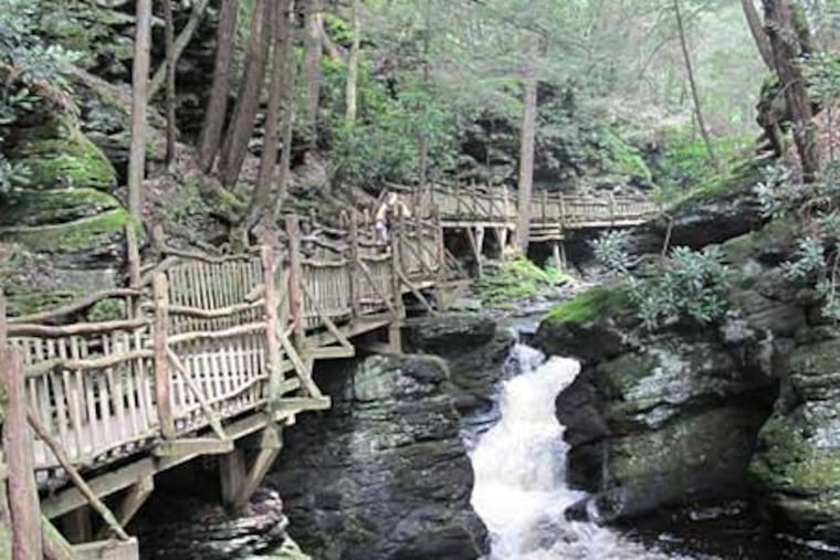 A wooden trail along a small waterfall and stream at Bushkill Falls in the Pocono Mountains.