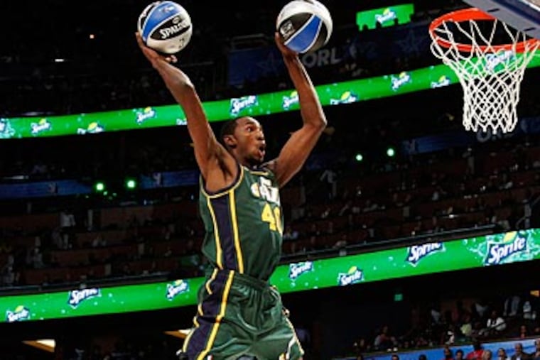 Jeremy Evans of the Jazz jumped over teammate Gordon Hayward and dunked two balls on Saturday. (Lynne Sladky/AP)
