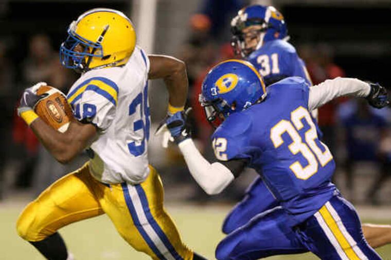 Downingtown East's Drew Harris is off to the races on a long gain that set up one of three Cougars second-quarter touchdowns. Harris had 208 yards on 29 carries and two TDs.