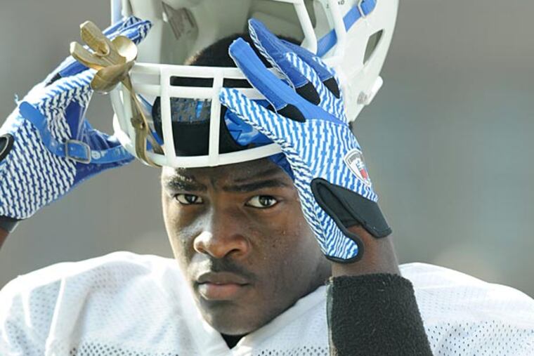 Paul VI receiver/linebacker Irving Charles puts his helmet on during a
scrimmage Sept. 5, 2013 against Camden High. ( CLEM MURRAY / Staff
Photographer )