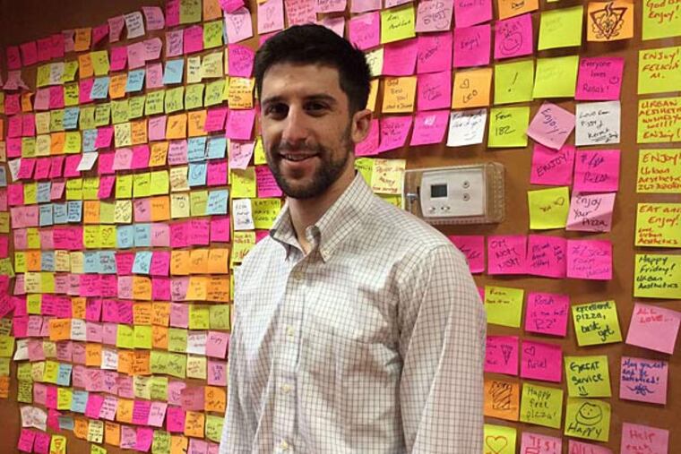 At Rosa's Fresh Pizza, owned by Mason Wartman, customers leave sticky notes of encouragement for the homeless after making $1 donations for slices of pizza. DYLAN SEGELBAUM / DAILY NEWS STAFF