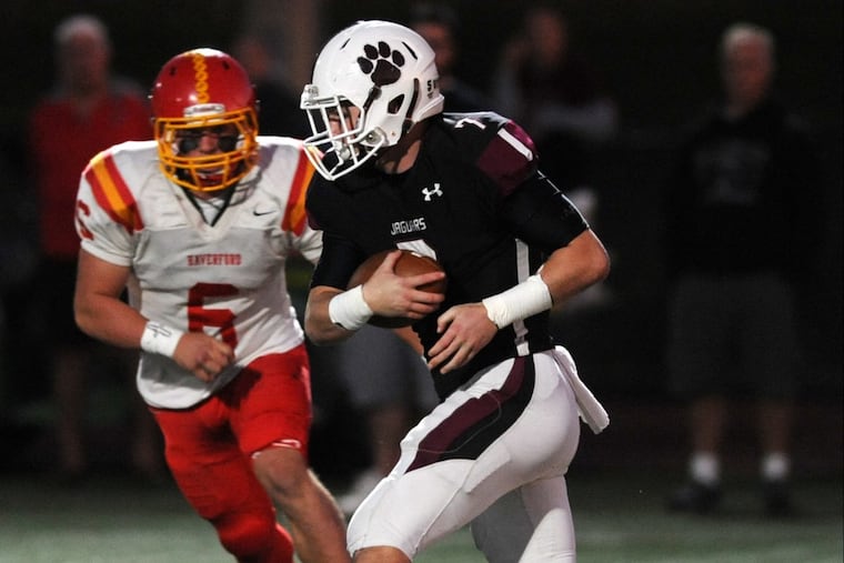Garnet Valley’s Danny Guy (right) runs past Haverford’s Pat Boyle in the first quarter of The Jaguars win over the pass-happy Fords.