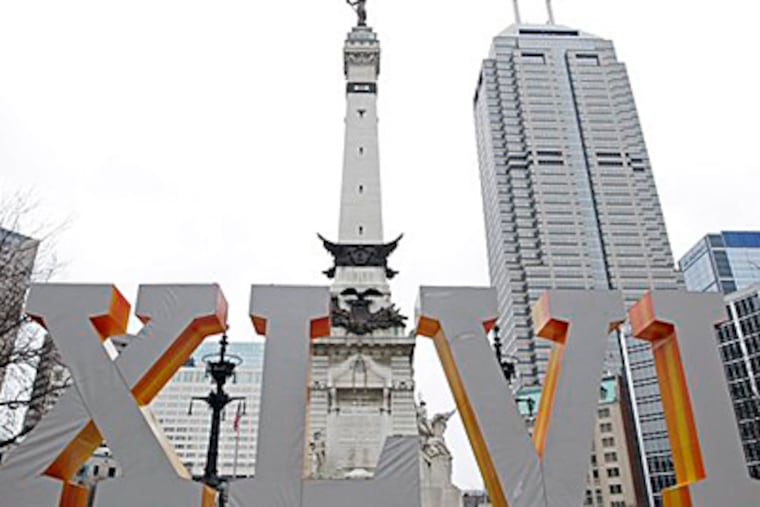 Roman numerals for Super Bowl XLVI frame the Soldiers and Sailors Monument at Monument Circle in downtown Indianapolis. (AP Photo/Michael Conroy, FILE)