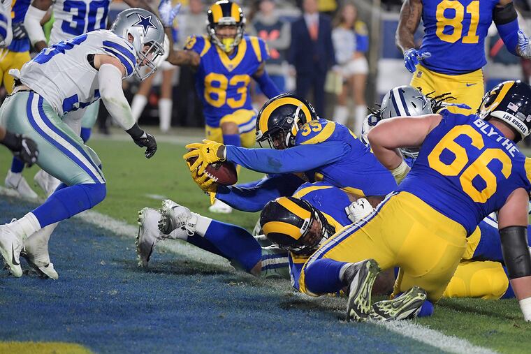 Los Angeles Rams running back C.J. Anderson (35) scores a second-quarter touchdown in front of Dallas Cowboys safety Jeff Heath (38) during the NFL Divisional Round at the Los Angeles Memorial Coliseum on Saturday, Jan. 12, 2019. (Max Faulkner/Fort Worth Star-Telegram/TNS)