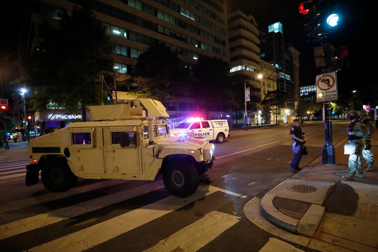 A military Humvee blocks an intersection along K Street in downtown Washington as demonstrators protest the death of George Floyd on Monday.
