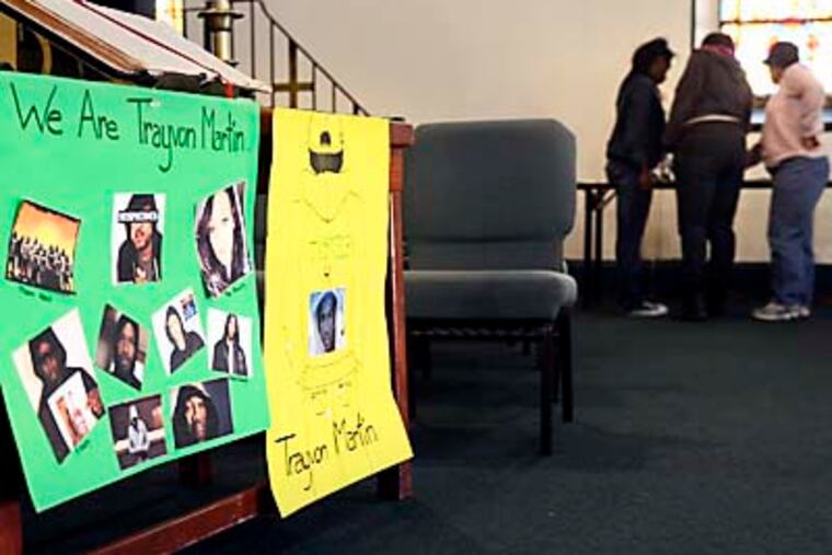 Neighborhood residents sign petition for Trayvon Martin at New Fellowship Baptist Church in Southwest Philadelphia April 4, 2012. ( TOM GRALISH / Staff Photographer )