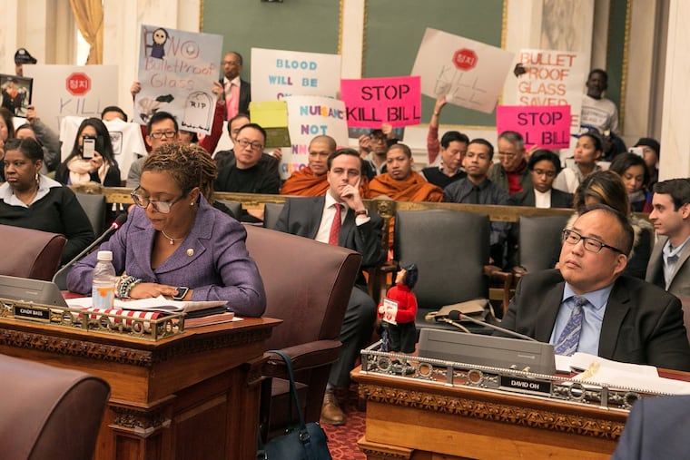 Councilwoman Cindy Bass, left, and Councilman David Oh shown here during a session of city council, at City Hall, much of the session focused on a controversial bill that would increase oversight on beer delis and Stop-N-Go shops, and could order the removal of bullet-resistant windows inside these businesses, Thursday, Dec. 14, 2017. JESSICA GRIFFIN / Staff Photographer