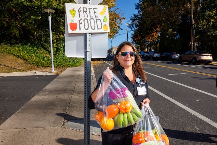 Abbe Stern, food-pharmacy manager for Children's Hospital of Philadelphia, joins volunteers distributing food outside of Karabots Pediatric Primary Care Center on Oct. 23.