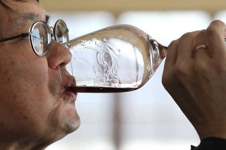 Mark Chien, Penn State Extension viticulture educator, tastes Galen Glen's Crooked Stick Red. MICHAEL BRYANT / Staff Photographer
