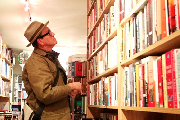 Chris Taylor shops books at Joseph A. Fox Booksellers.