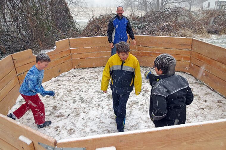 Hebrew School at Congregation Beth Israel teacher Alex Dresner plays with students in the snow inside their new gaga pit made from recycled wood. (Congregation Beth Israel Photo)