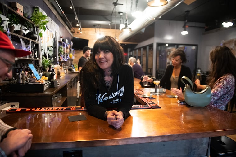 Jennifer Sabatino, director of bar operations for Manatawny Still Works, behind the bar at the tasting room in Ardmore.