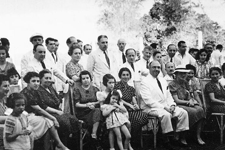 Alex Frieder (seated center) with refugees at a Jewish Community meeting in 1940. (handout photo)