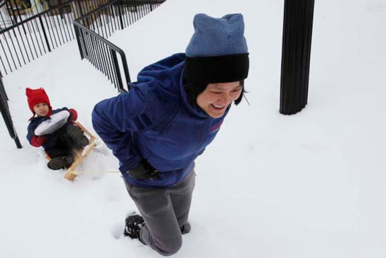Susan Liu pulls her son James Adams, 3, through snow in Paoli. Her work was closed and his day care was closed. February 13, 2014. ( MICHAEL S. WIRTZ / Staff Photographer )