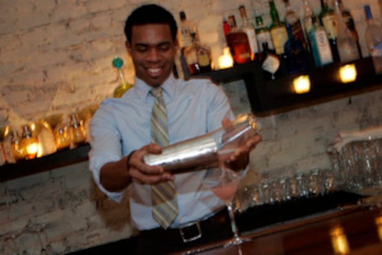 Bartender Theo Webb pours a drink. A hot apple cider spiked with hot rum is a welcome libation these nippy days, served with a bowl of roasted chestnuts.