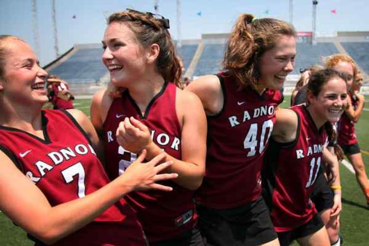 (From left) Molly Samson, Leah Gallagher, Moira Mahoney, and Anny Junior celebrate after defeating Springfield of Delaware County, 14-7, in the PIAA state championship game at HersheyPark Stadium. It was the third time Radnor (26-1) has beaten Springfield-Delco (22-3) this season.