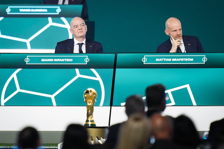 The World Cup trophy on stage in front of FIFA president Gianni Infantino (left) and secretary general Mattias Grafström.