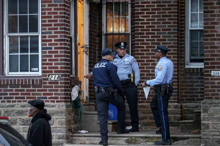 Philadelphia Police Department officers stand outside a home where a 2-year-old was found with a gunshot wound to the head in the 200 block of West Godfrey Avenue in Olney on Thursday, Nov. 9, 2017. A family member drove the child to Einstein Hospital, where he was pronounced dead.