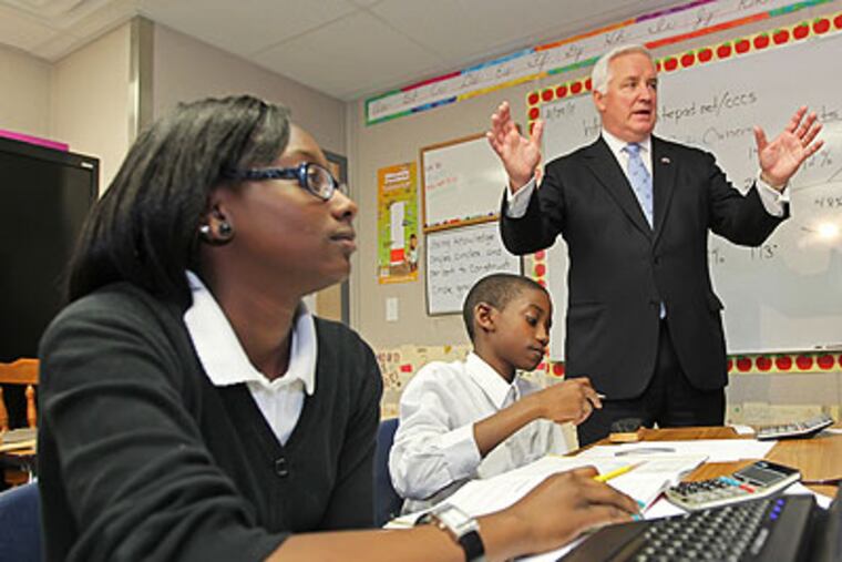 Gov. Tom Corbett, right, talks to a 6th grade enrichment class about mathematics while Chester Community Charter School students Essence Goodwin, 12, left, and Fasaad Johnson, 12, center, listen intently. (Michael Bryant / Staff Photographer)