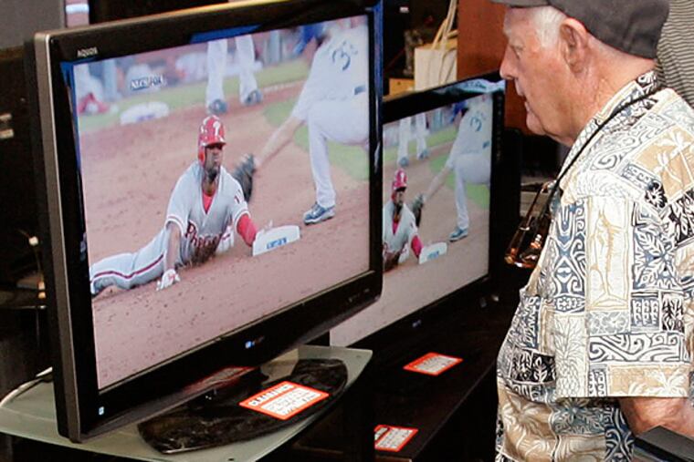 A man watches the Phillies play while shopping for a new television. (AP Photo/Paul Sakuma)
