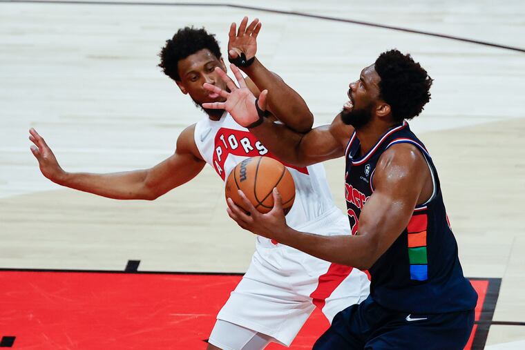 Toronto Raptors forward Thaddeus Young defends Sixers center Joel Embiid during Game 4 in Toronto.