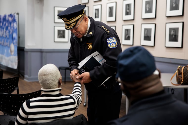 Police Commissioner Kevin Bethel greets Pamela Chase, Director of the Group Violence Intervention program, before a community meeting at a church in the 22nd Police District in December.