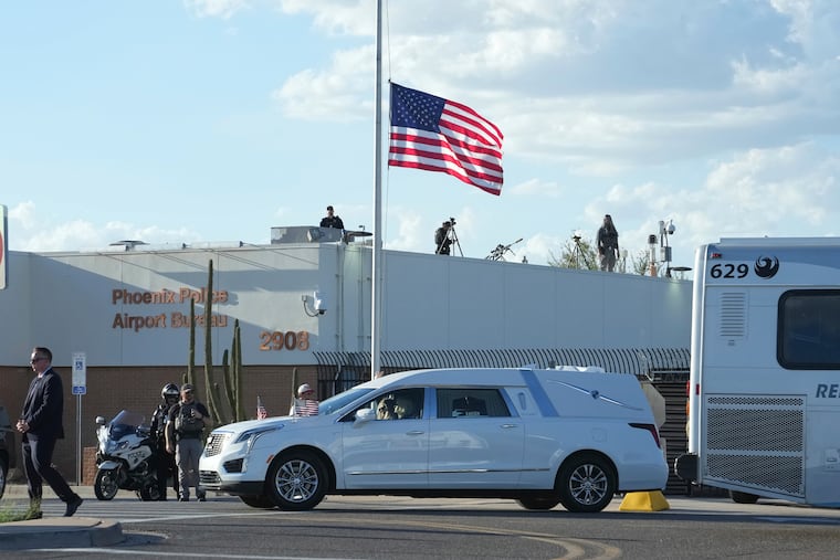 A hearse containing the body of Charlie Kirk, the CEO and cofounder of Turning Point USA, who was shot and killed on Wednesday, leaves Phoenix Sky Harbor International Airport on Thursday after a flight there from Utah on Air Force Two.