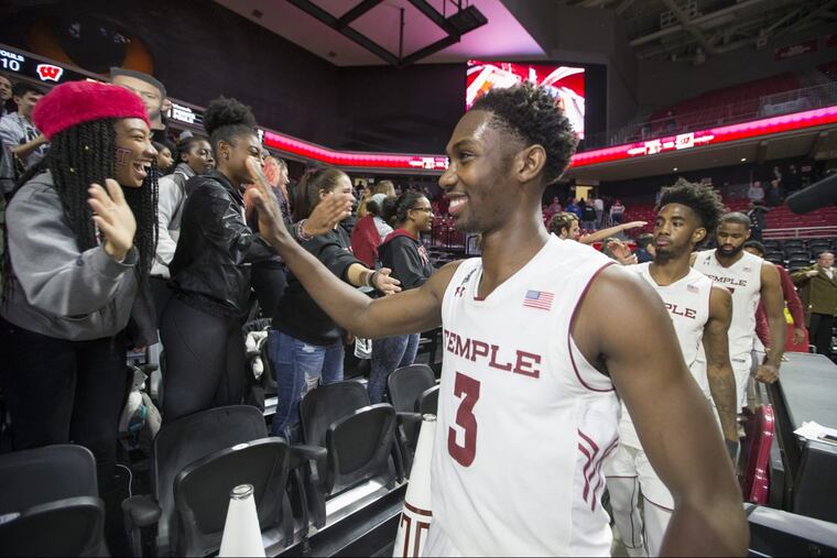 Shizz Alston,. high-fiving members of the student section after the Owls’ 59-55 victory over Wisconsin,