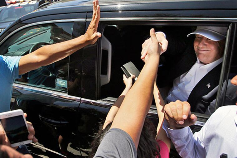 Supporters reach out to Republican presidential candidate Donald Trump in Laredo, Texas, on Thursday. Associated Press