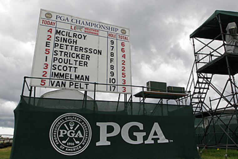Storm clouds are seen behind the scoreboard after play was halted for weather during the third round of the PGA Championship. (AP Photo/John Raoux)