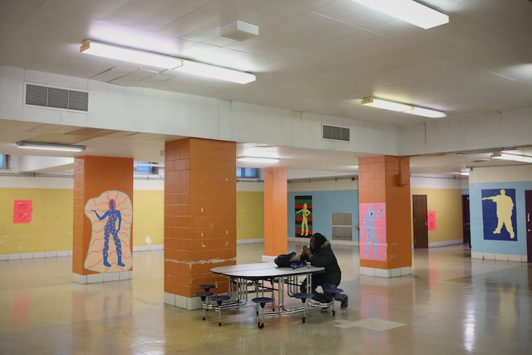 Senior Charnel Crockton eats breakfast alone in the cavernous cafeteria at Strawberry Mansion High School in Philadelphia on Tuesday, Dec. 18, 2018. The school, built for up to 1,800 students, enrolls 169 this year.