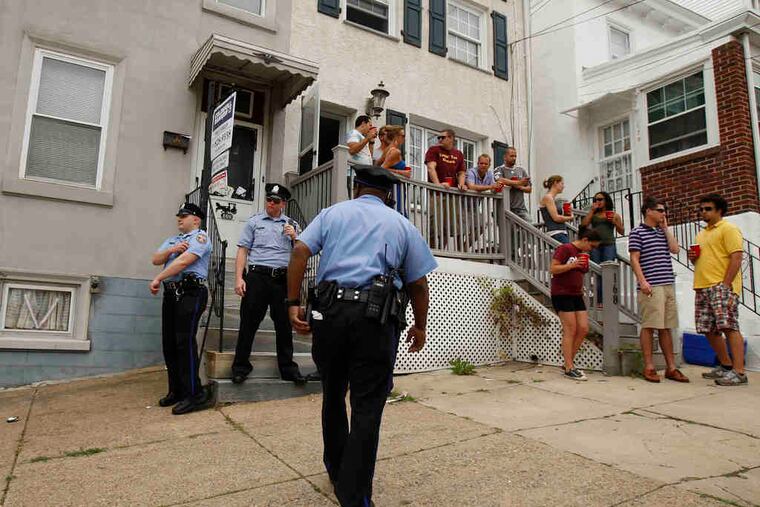 Philadelphia police offficers patrol "The Wall" in Manayunk, responding to complaints that drinking and fighting have marred earlier versions of the international cycling championship.
