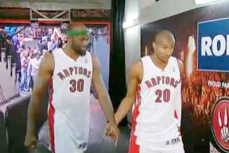 The Web is all a'twitter over Reggie Evans (left) and Leandro Barbosa holding hands after a game. (YouTube)