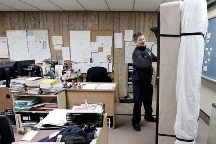 Willingboro Fire Department Capt. Brian Gardner pulls out his bed in the captains office at the Willingboro Firehouse on Charleston Road on Jan. 14, 2015. Lack of space in the current building means that some firefighters, including Gardner, must sleep in other parts of the firehouse. ( ELIZABETH ROBERTSON / Staff Photographer )