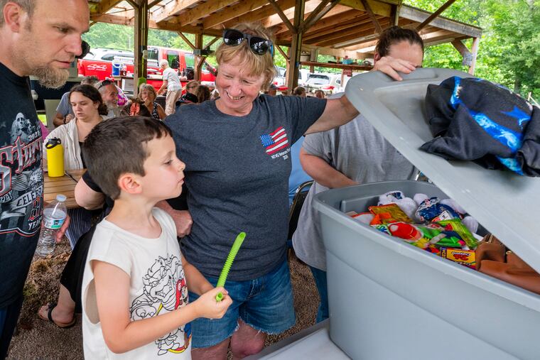 Darlene Fenton (center) a Republican Sullivan County Commissioner, lets Daniel Kieser, 5, choose his prize from the toy bin in a game during a family reunion in Forksville June 23, 2024. 
