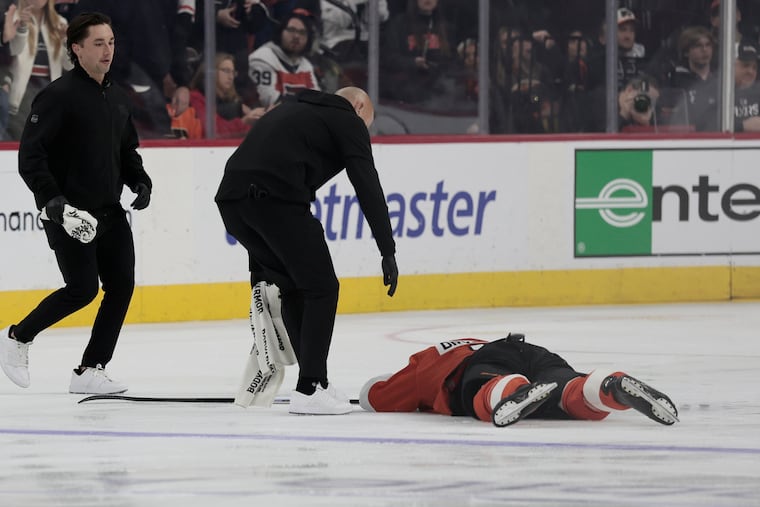 Flyers defenseman Jamie Drysdale lays on the ice after a blindside hit by Anaheim Ducks' Ross Johnston. Drysdale did not return.