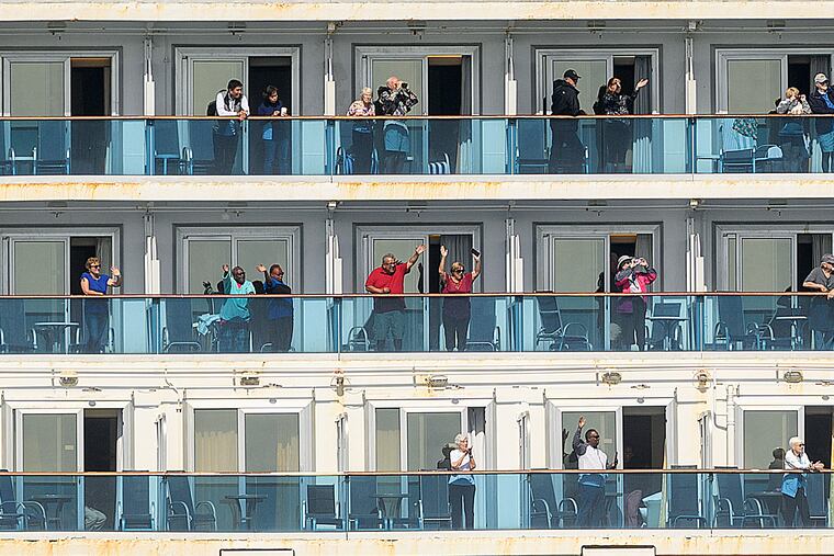 Passenger aboard the Grand Princess celebrate as they arrive in Oakland, Calif., on Monday, March 9, 2020. The cruise ship, which had maintained a holding pattern off the coast for days, is carrying multiple people who tested positive for COVID-19.