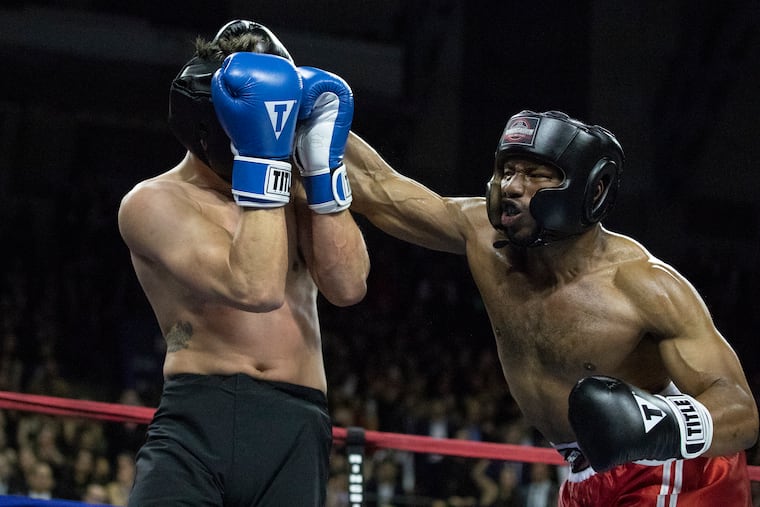 Alexander Dawson of Penn Law (right) and Marek Malik of Wharton fight in the heavyweight bout at Penn Fight Night at the Palestra Saturday.