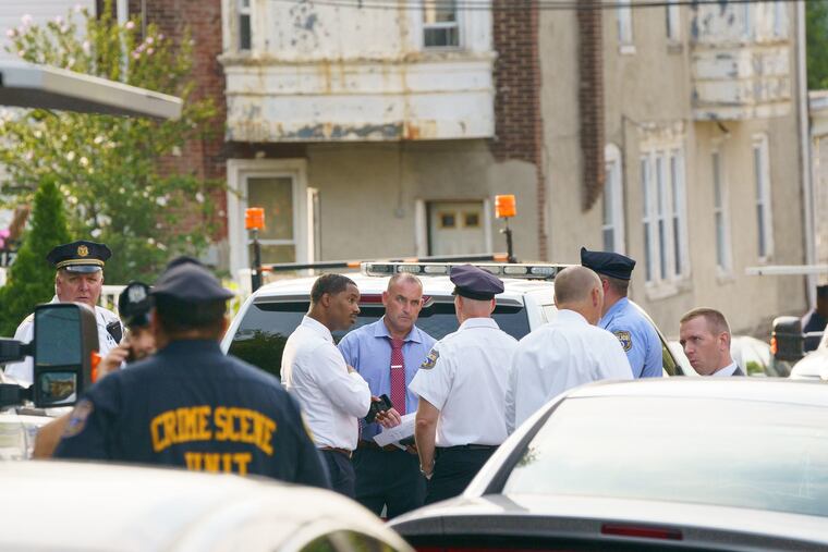 Police investigate the shooting of a police officer on the 4800 block of Knox Street, in Philadelphia, Monday.