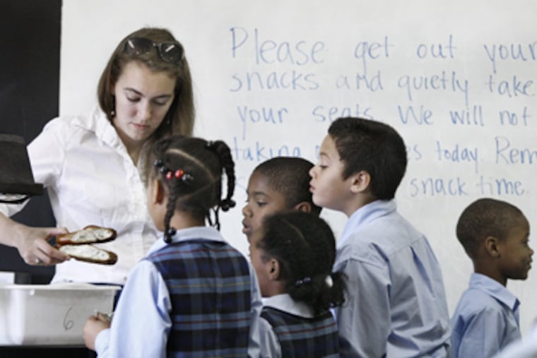 It's snack time in Meghan Bliss's third grade class at St. Rose of Lima parish school on Wanamaker Street in Philadelphia last September. (Elizabeth Robertson / Staff Photographer)