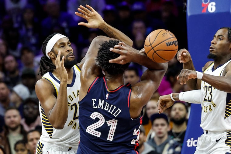Sixers Joel Embiid is surrounded by Pacers Isaiah Jackson left and Aaron Nesmith during the 1st quarter at the Wells Fargo Center in Philadelphia, Tuesday, November 14, 2023.