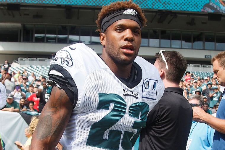 Philadelphia Eagles safety Rodney McLeod, right, comes onto the field
with linebacker Najee Goode, center, and defensive end Brandon Graham, left, during practice at NFL football training camp, Sunday, July 31, 2016, in Philadelphia.