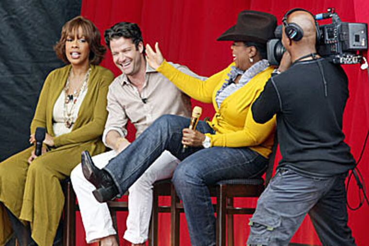 Gail King, Nate Berkus and Oprah Winfrey sing and joke with one another as country singer Martina McBride (not shown) performs during the taping of "The Oprah Winfrey Show" at the State Fair of Texas on Oct.12, 2009. (David Woo / Dallas Morning News / MCT)