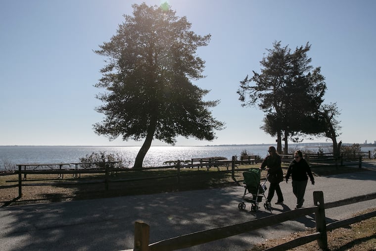 People walk around John F. Kennedy Park in Somers Point on Wednesday when the weather made a run at spring. Don't get used to it.