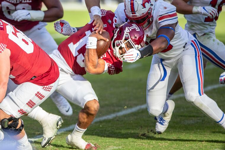 Temple quarterback Re-al Mitchell is tackled by SMU lineman Junior Aho in Saturday's loos.