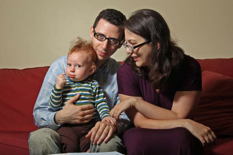 Ari Friedman, Tara Mendola , and Erik, now 15 months old. It was a six-month ordeal before the parents, both graduate students, got their son enrolled in the Children's Health Insurance Program. MICHAEL BRYANT / Staff Photographer